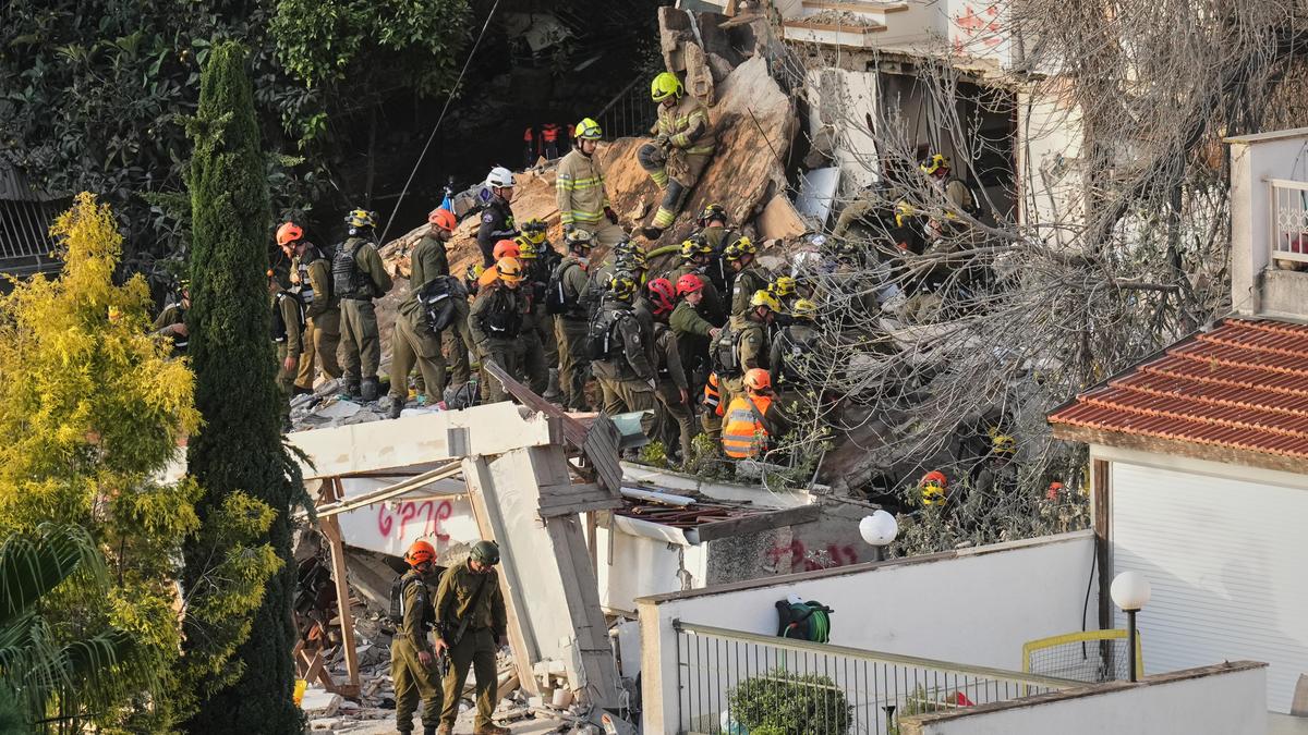 Israeli rescuers search for missing in building strike by Iranian missile, two dead